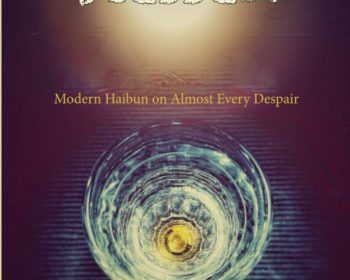 The cover of "Blessed: Modern Haibun on Almost Every Despair" by Andrew Riutta features a glowing white circular light at the top, resembling the moon. Below is a translucent glass with intricate light reflections. The title and author’s name are in white and yellow fonts.